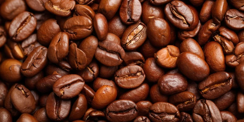 Close-up of roasted coffee beans densely packed and glossy