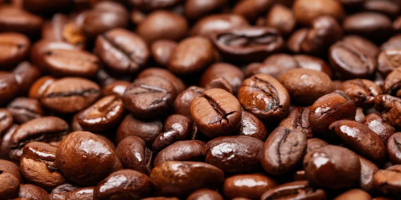 Close-up of roasted coffee beans densely packed and glossy with rich brown color