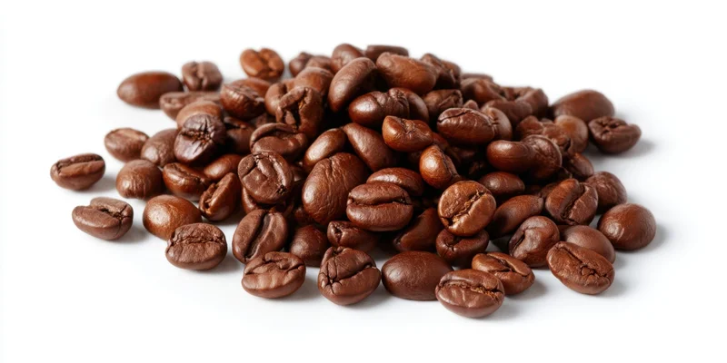 Roasted coffee beans scattered in a pile on a white background