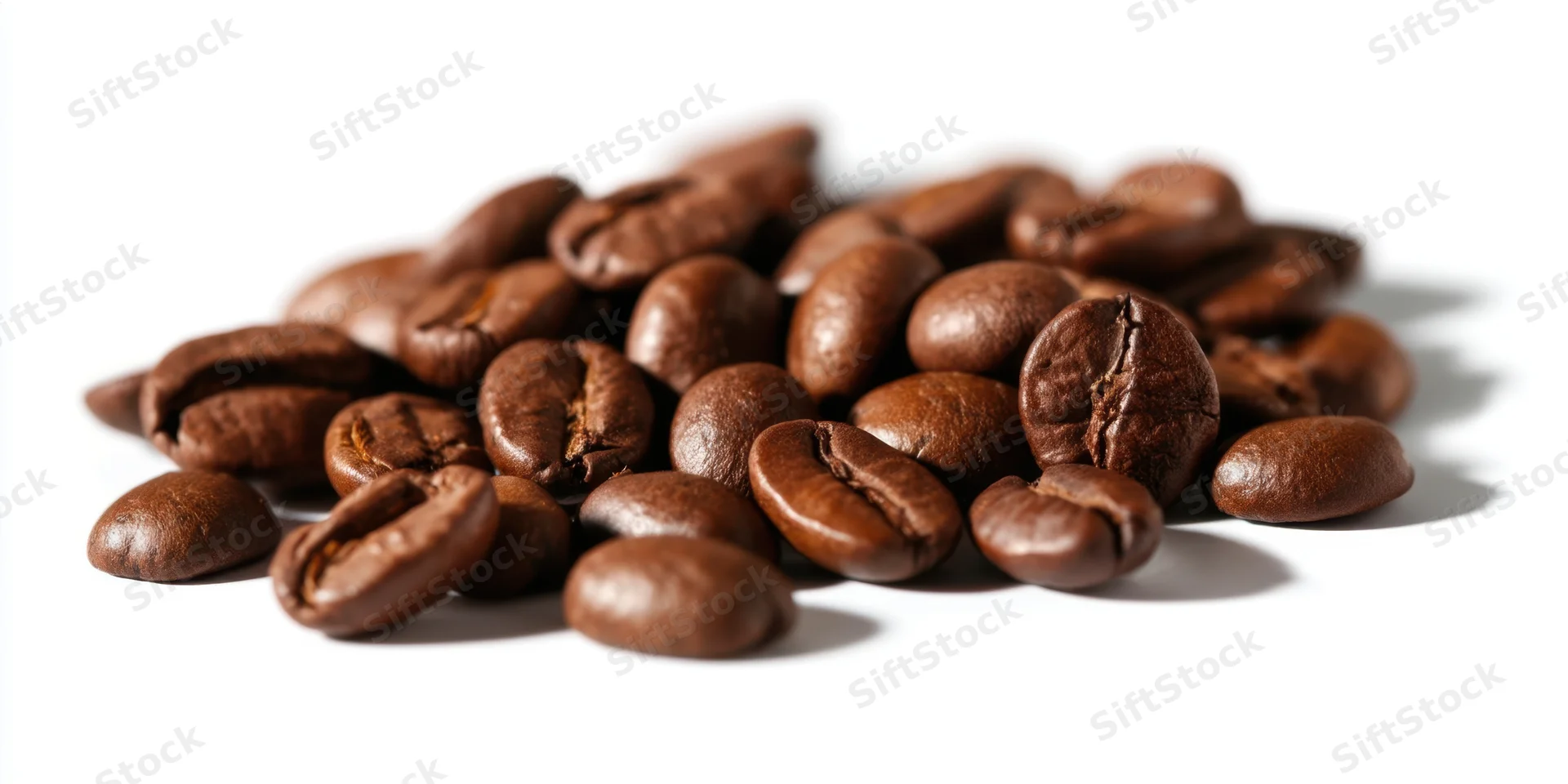 Roasted coffee beans piled on a white background