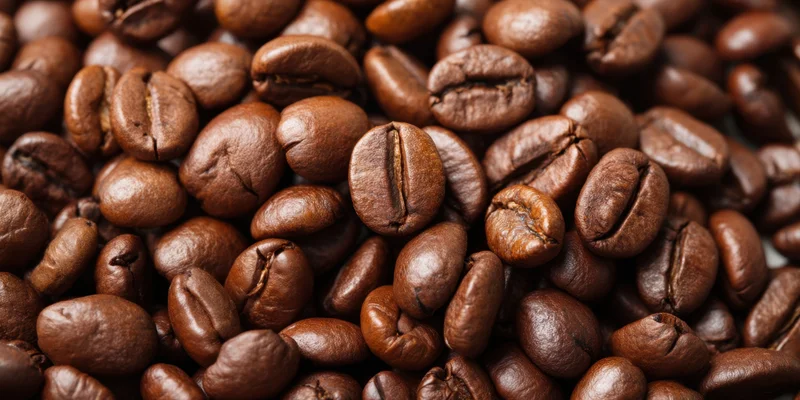 Closeup of glossy roasted coffee beans filling the frame