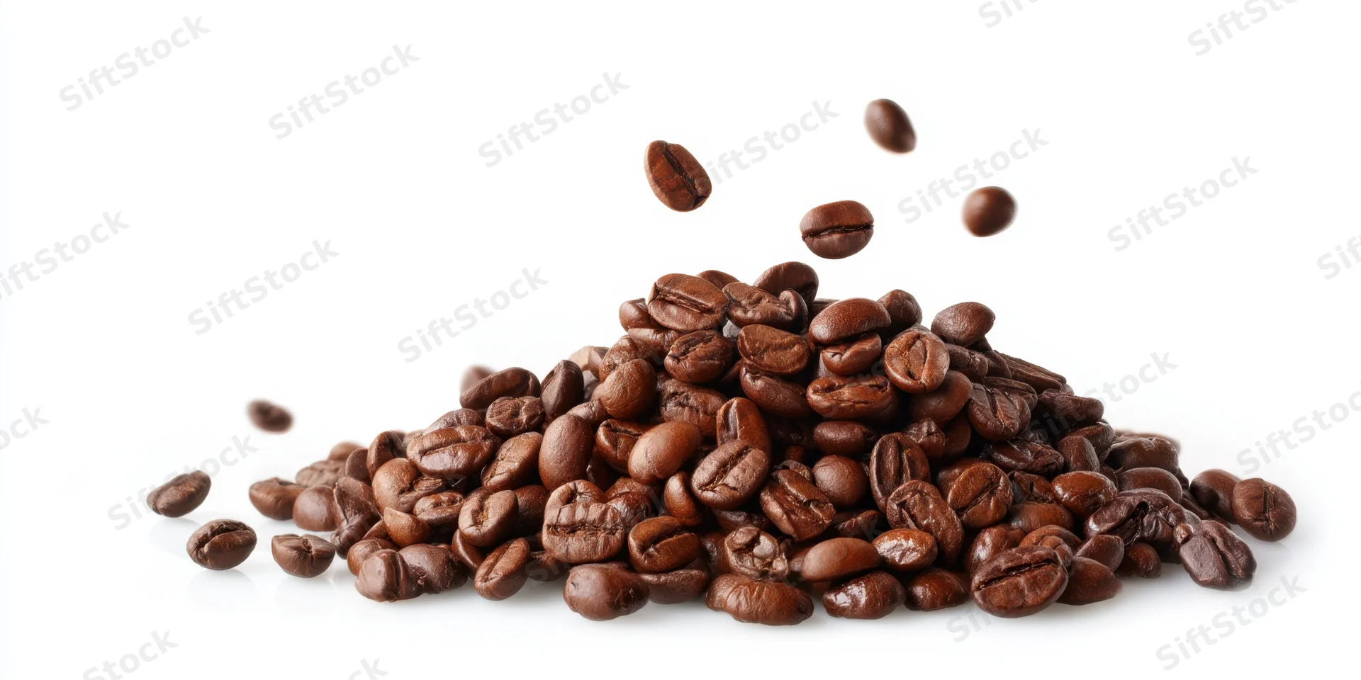 Pile of roasted coffee beans with some falling, on white background