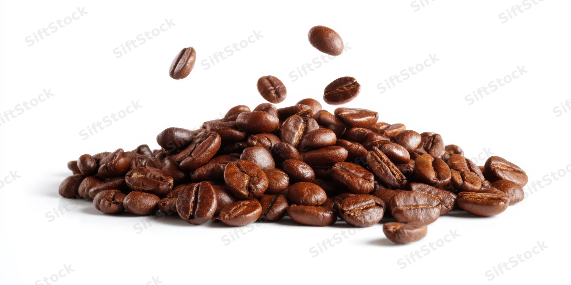 Roasted coffee beans piled on white background with some falling mid-air