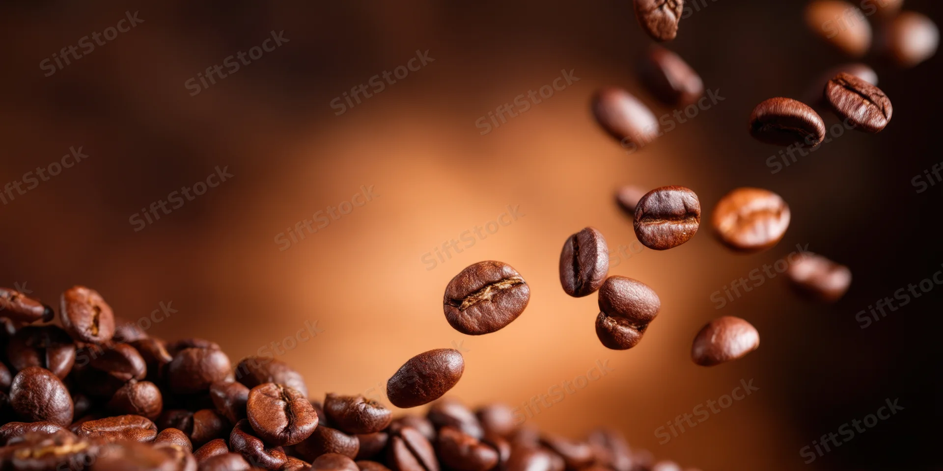 Roasted coffee beans floating in midair above a pile against a warm blurred background