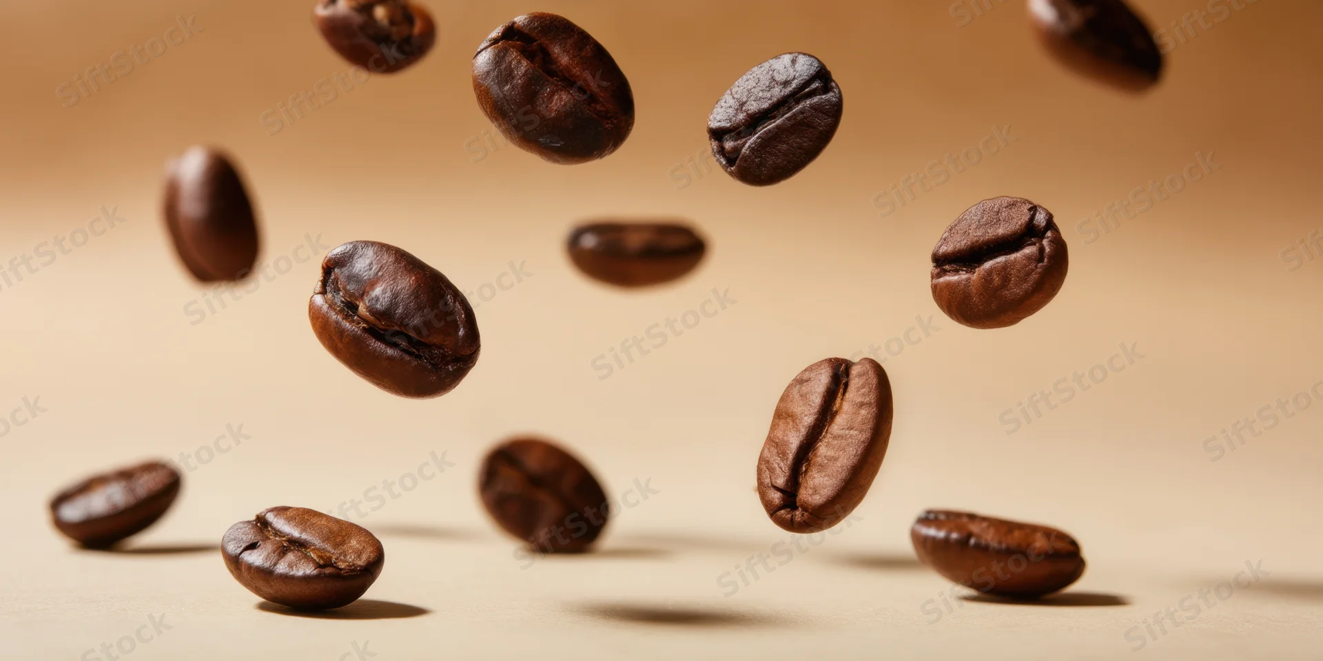 Roasted coffee beans floating in midair above a warm beige surface