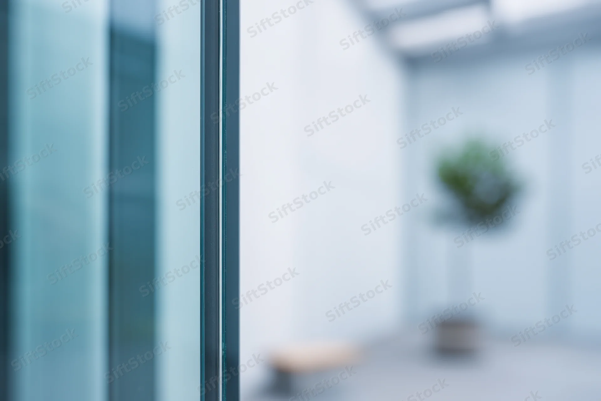 Close-up of a glass window pane with reflections in a modern office interior