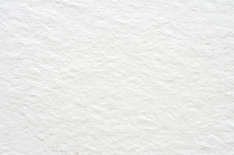 Textured off-white paper surface filling the frame as a neutral background