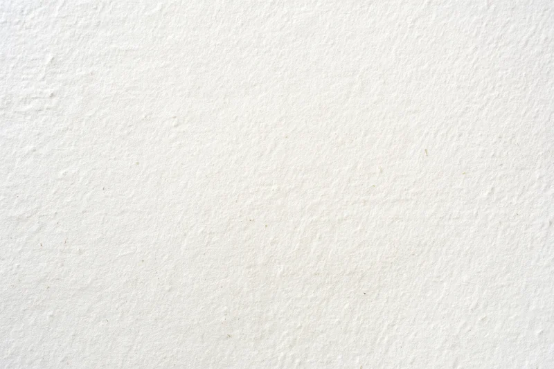 Textured off-white surface filling the frame as a neutral background