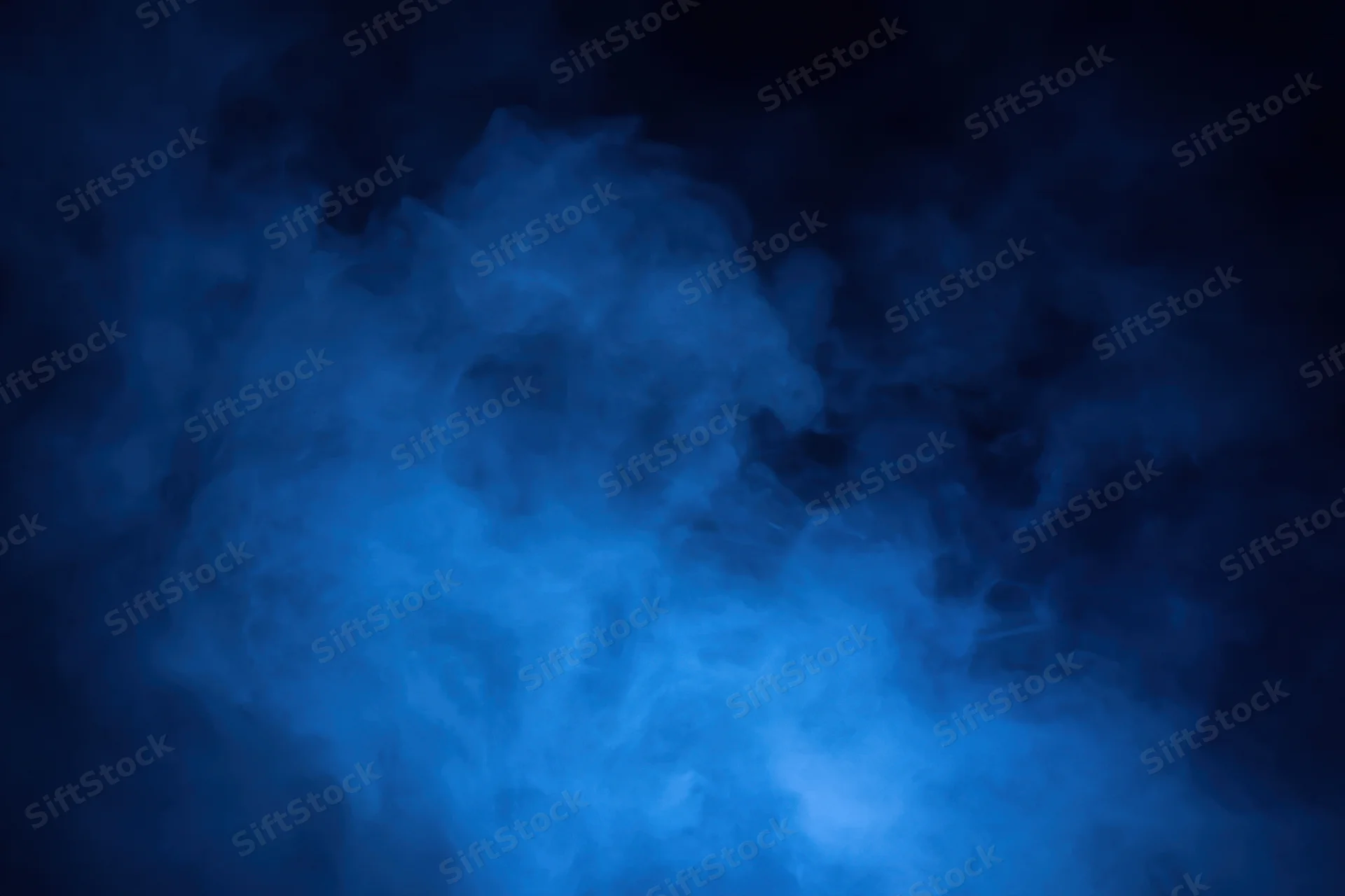 Blue smoke drifting in dark atmosphere