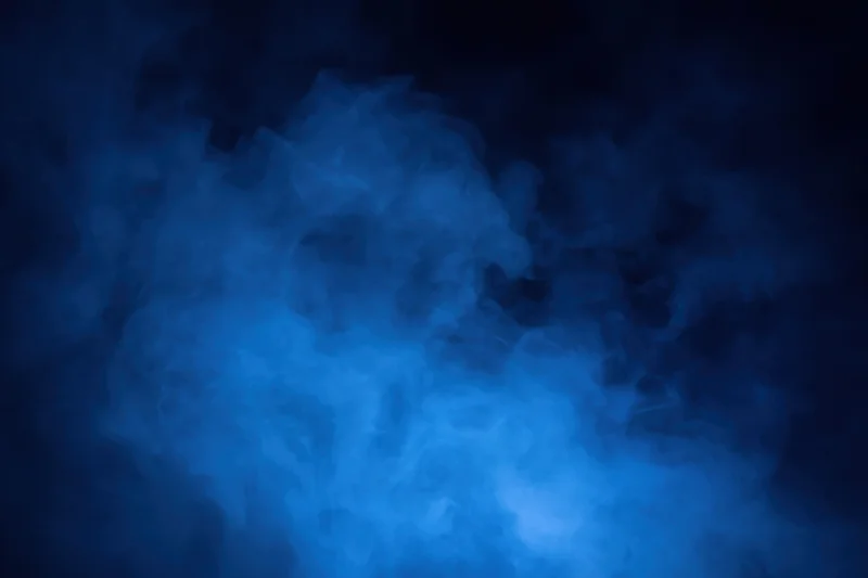 Blue smoke drifting in dark atmosphere