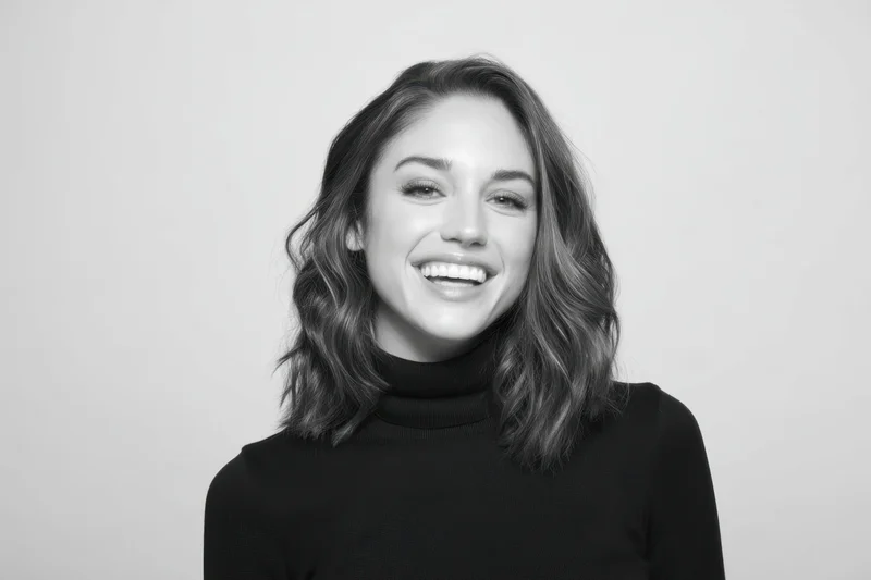 Smiling woman with shoulder-length hair in black turtleneck