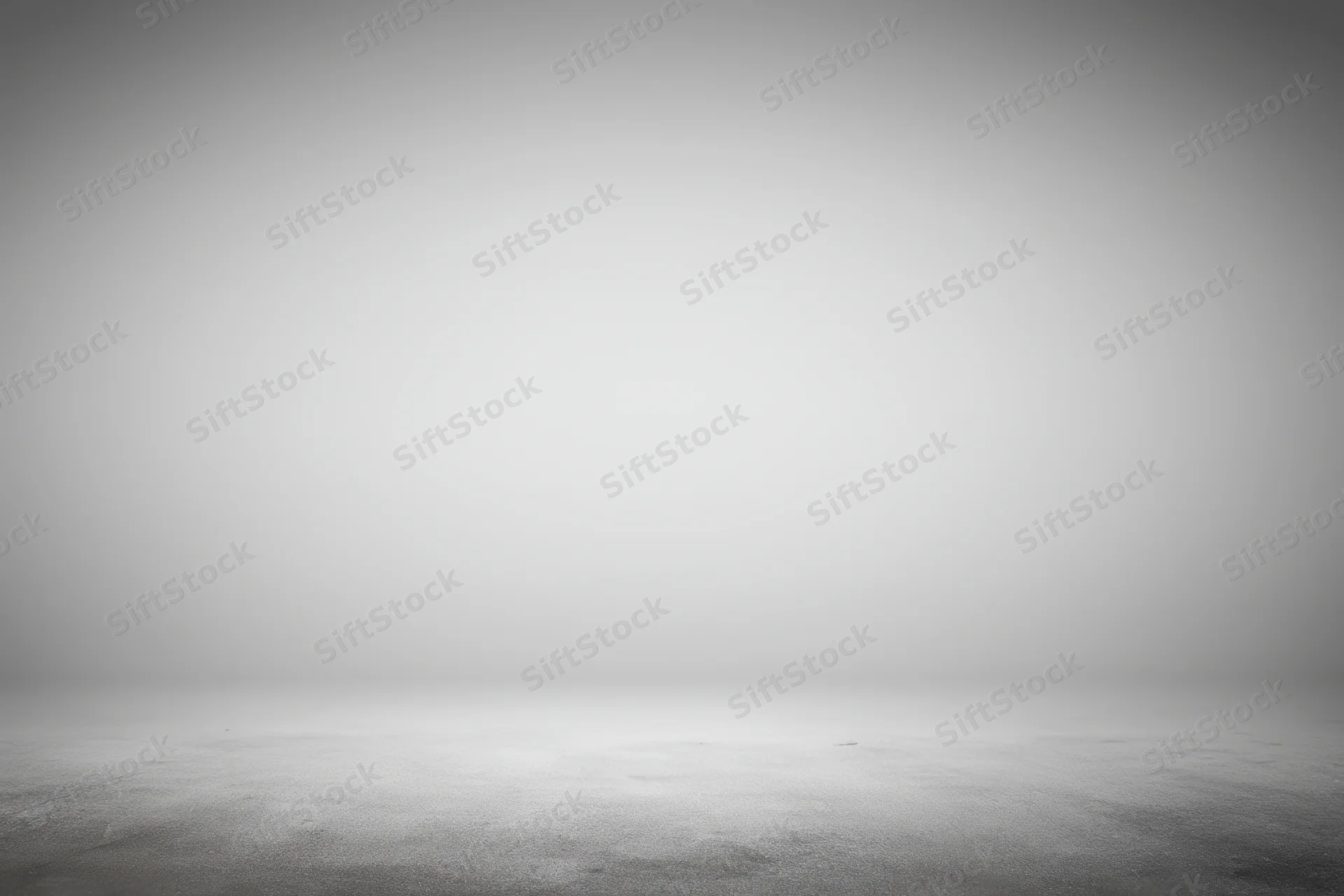 Smooth neutral gray studio backdrop with soft gradient and empty floor space