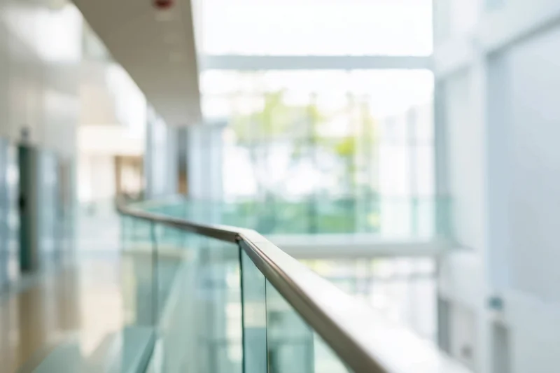 Modern office hallway with glass railing and bright interior space