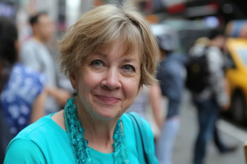Senior woman smiling in closeup portrait on busy city street