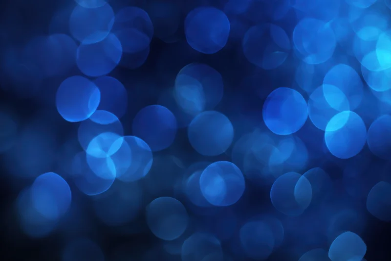 Deep blue bokeh background with softly glowing circular lights