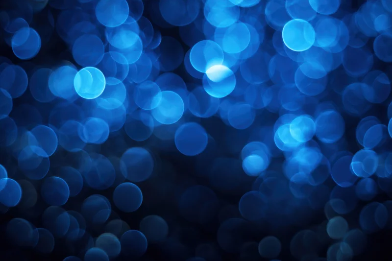Deep blue bokeh background with softly glowing circular lights