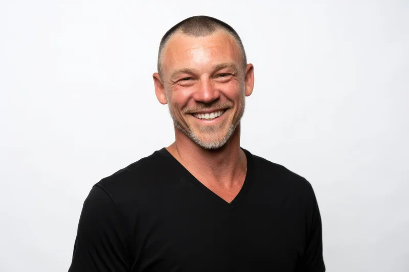Smiling man in black v-neck t-shirt against white background
