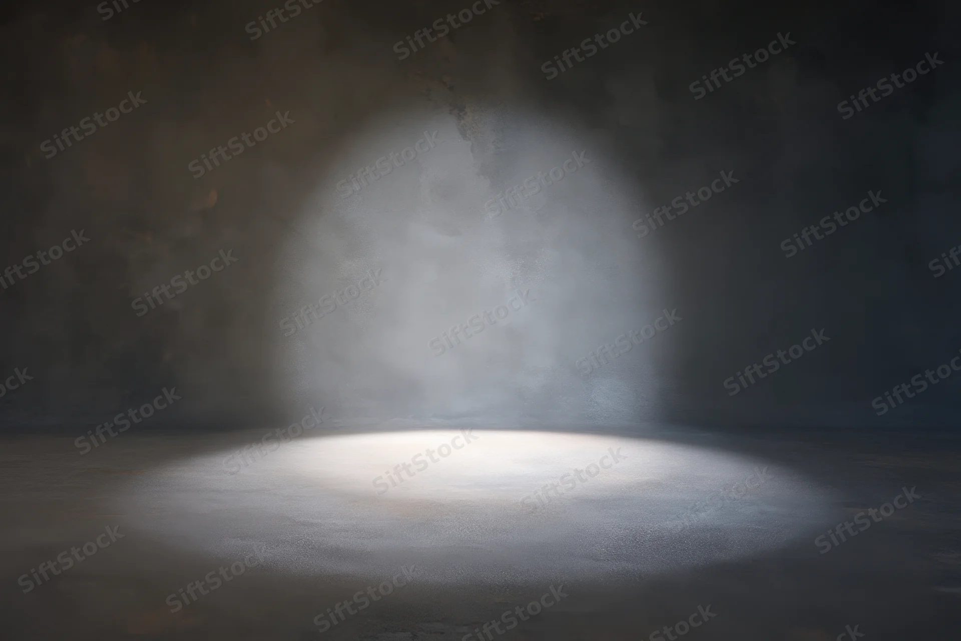 Spotlight illuminating an empty textured studio floor and wall