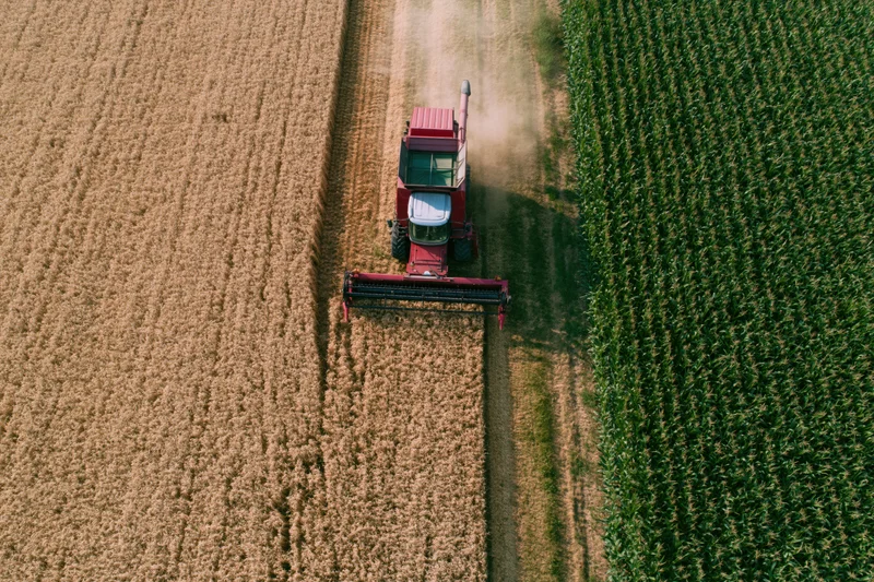 Aerial drone shot looking down at a red combine harvester
