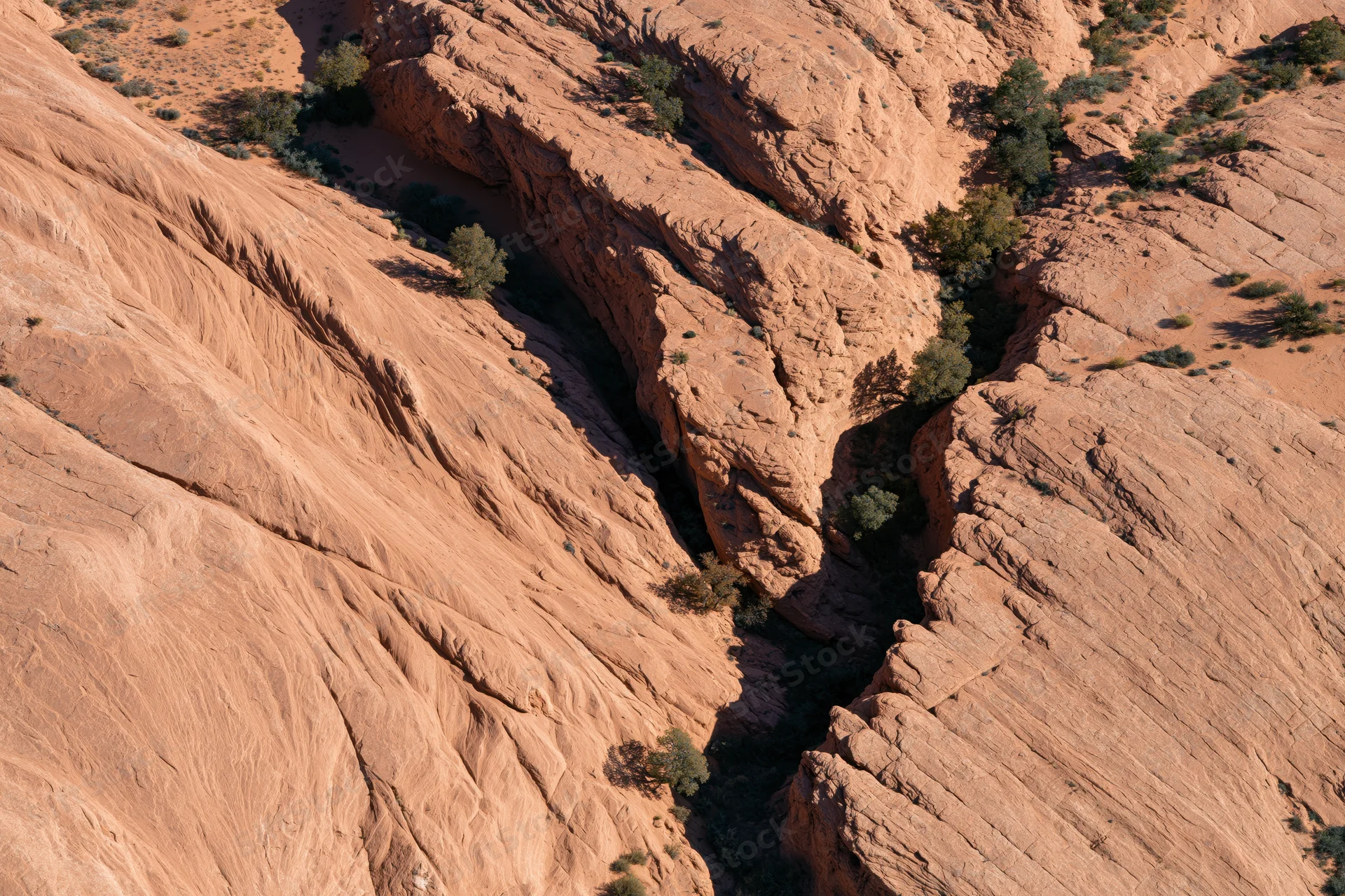 Aerial top-down view of red sandstone canyon landscape in desert terrain