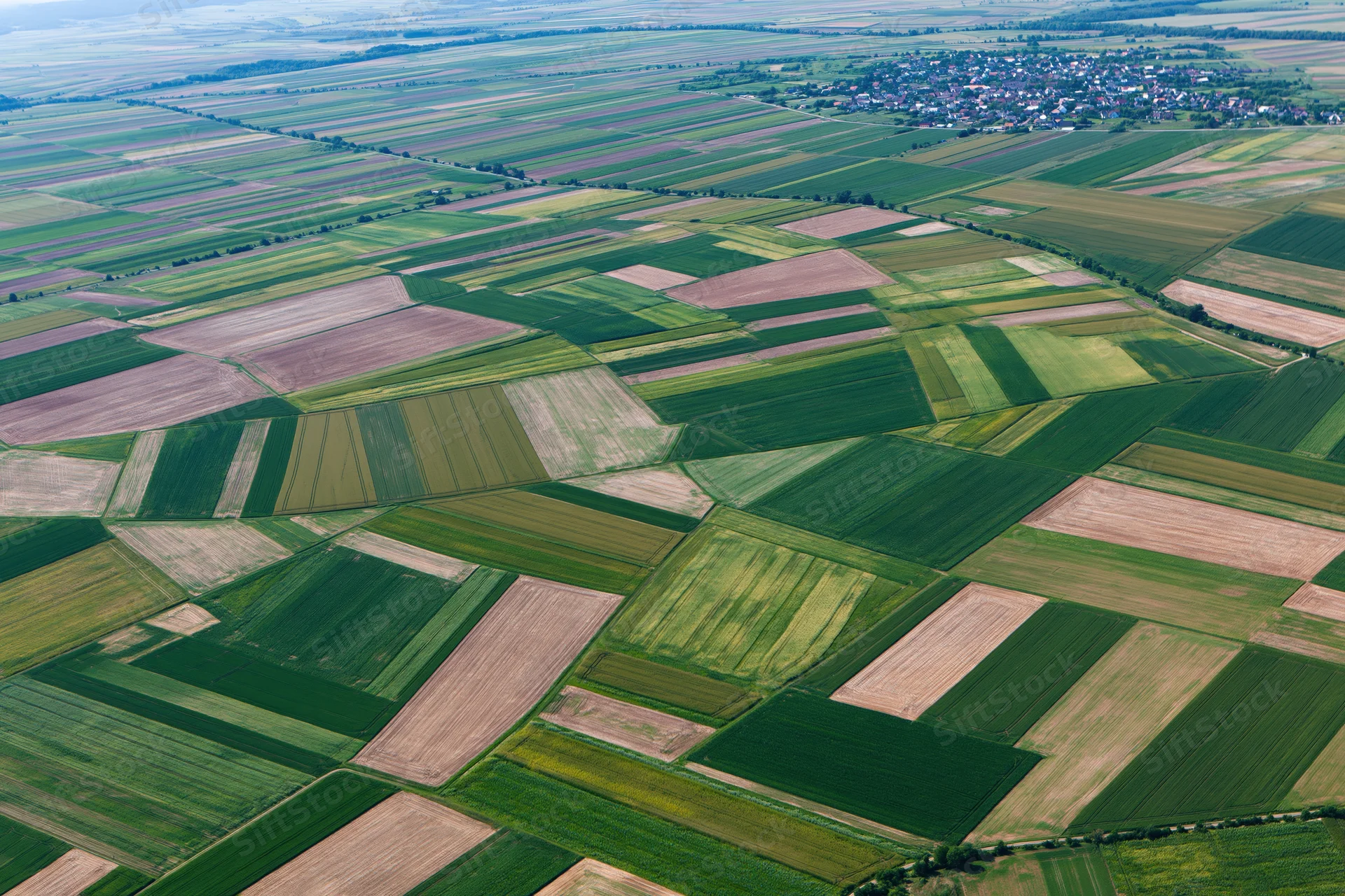 Aerial view of patchwork farmland fields in rural europe