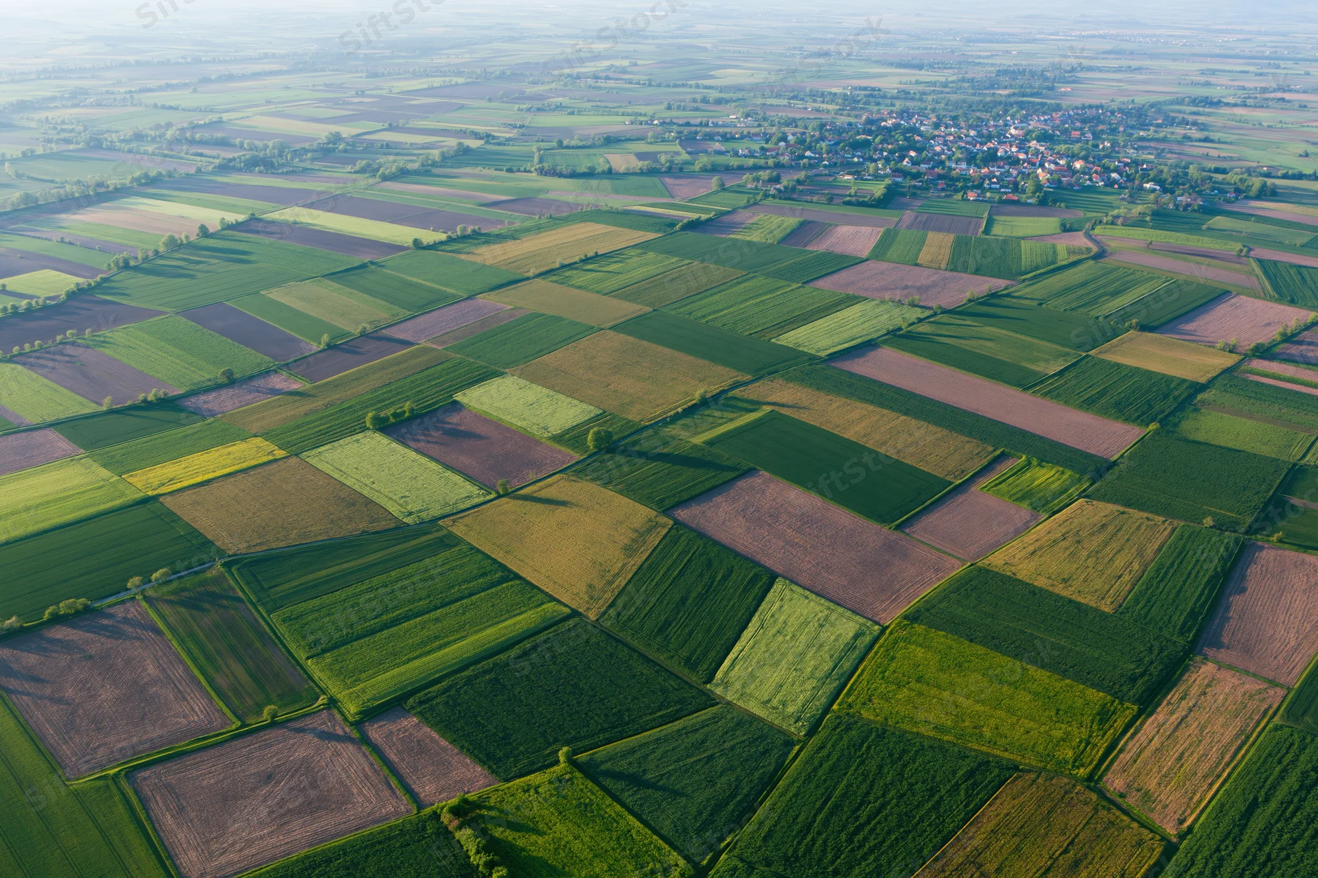 Aerial view of patchwork farmland fields in rural europe