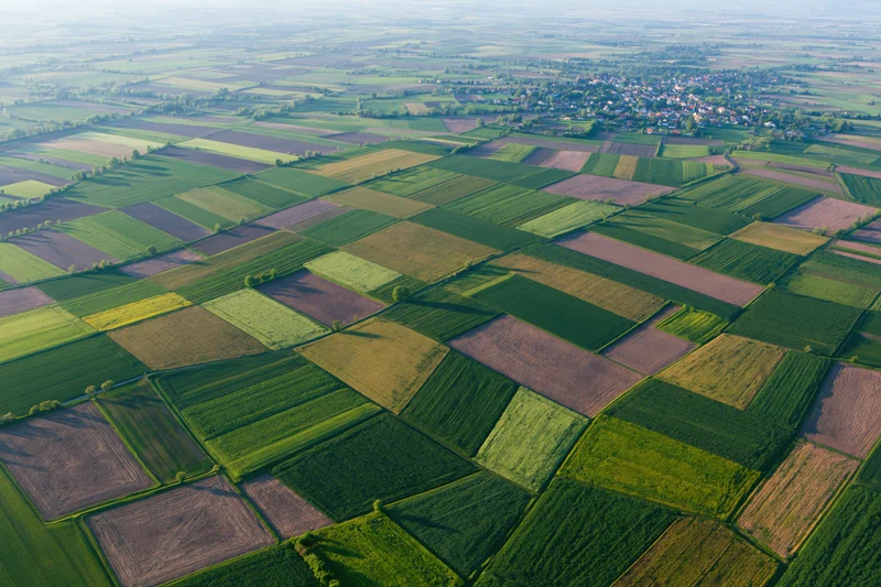 Aerial view of patchwork farmland fields in rural europe