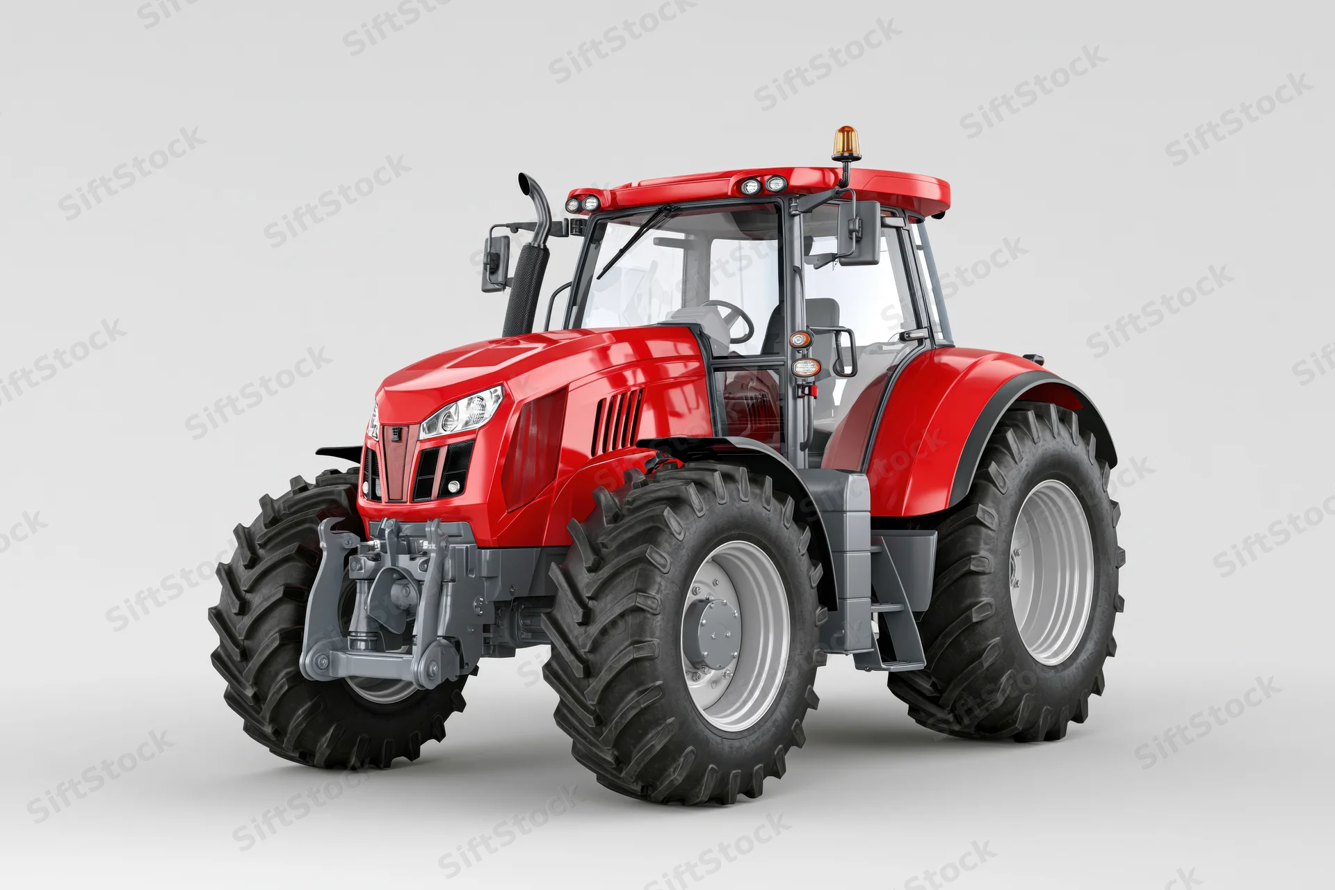 Red agricultural tractor parked stationary in studio setting