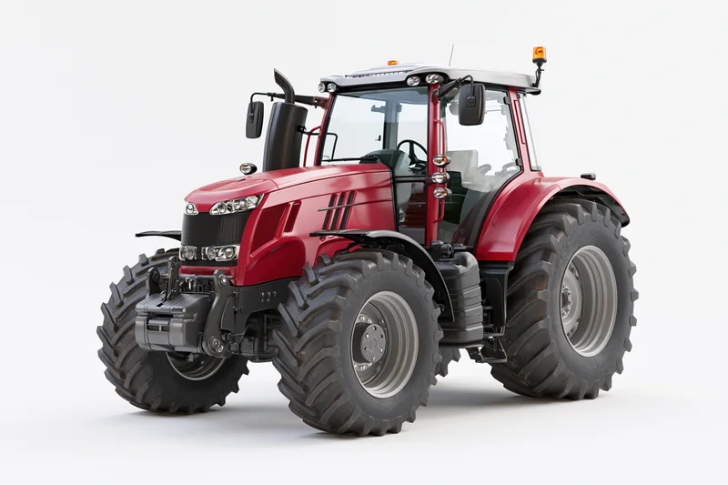 Modern red agricultural tractor with enclosed glass cab parked in studio setting
