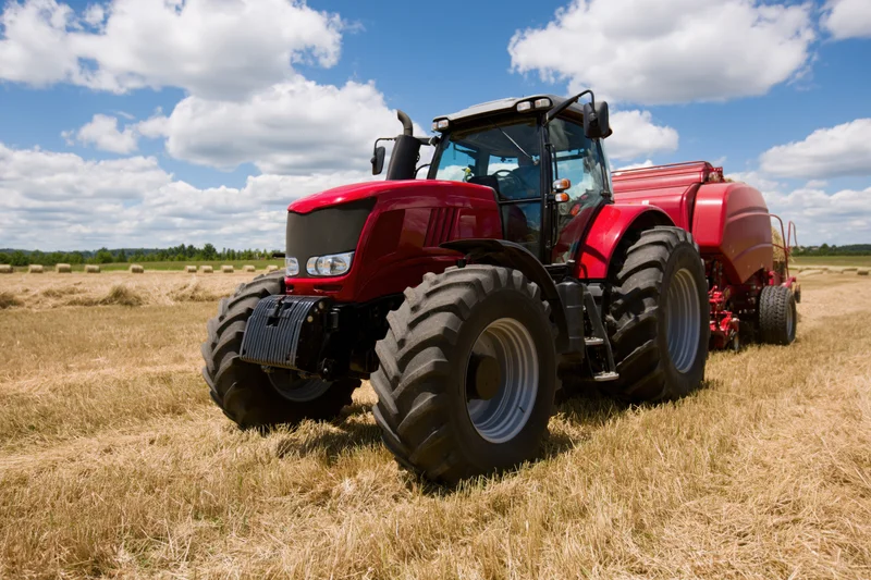 Tractor in a Golden Field Under a Bright Blue Sky