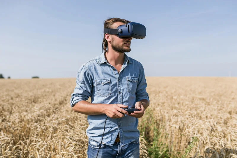 Stock photo. Man wearing VR headset in field