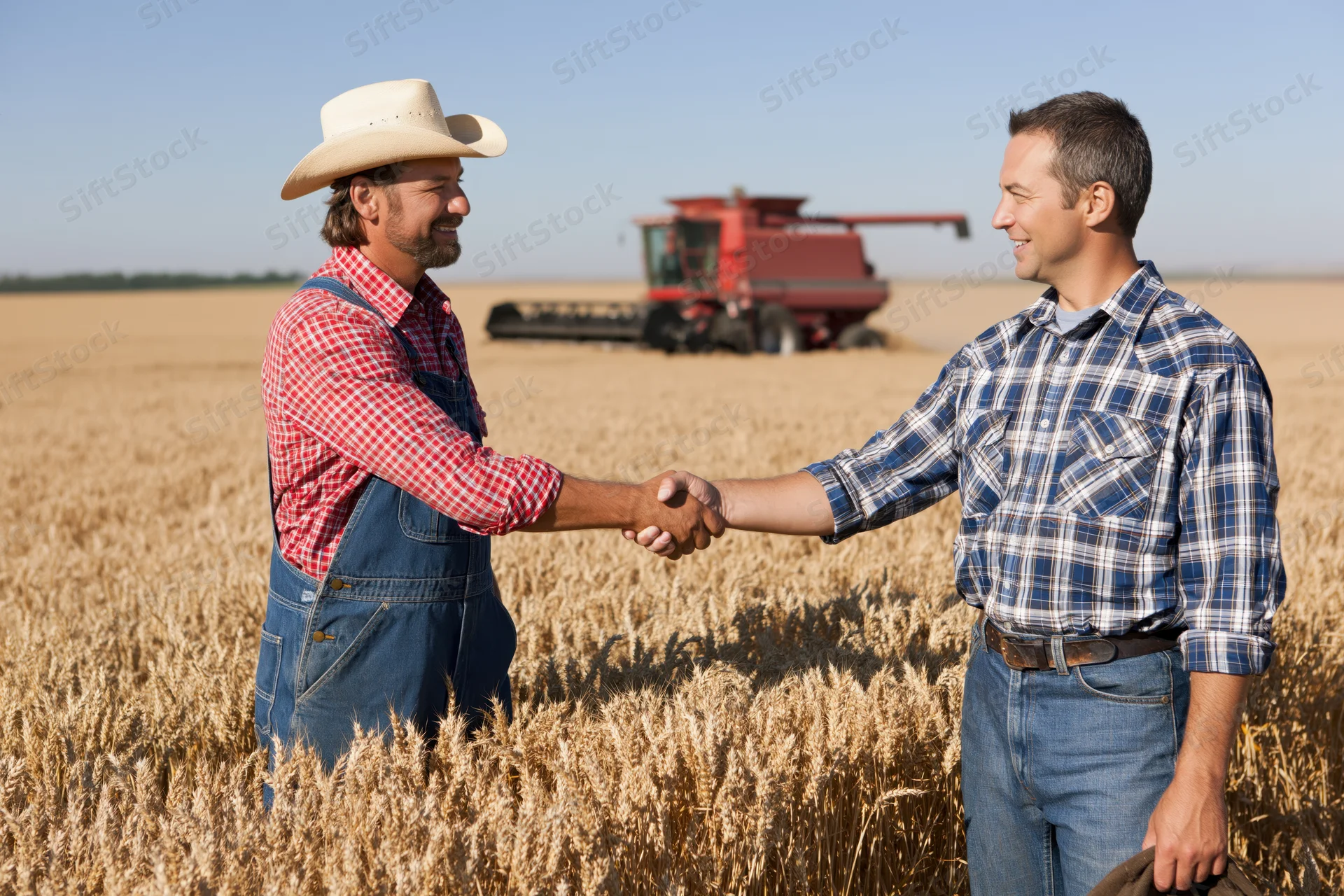 Two farmers shaking hands in a wheat field with a combine harvester in the background