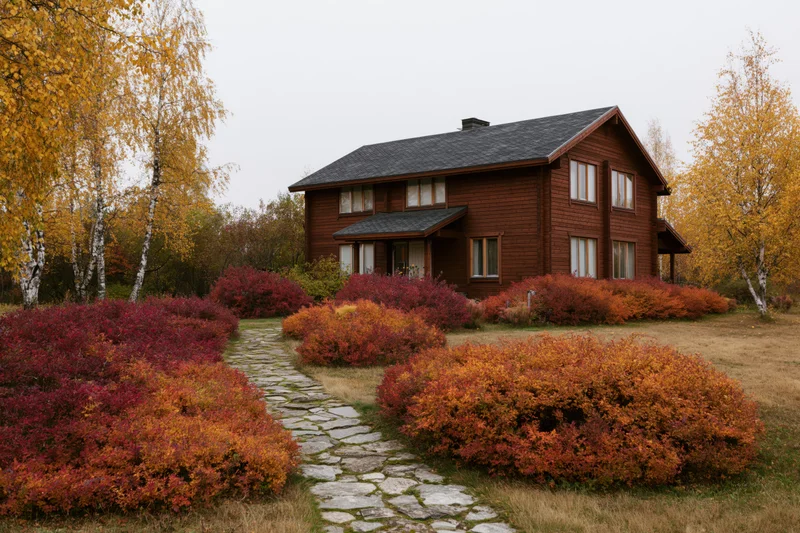 Two-story brown wooden country house with dark shingle roof surrounded by autumn foliage and stone pathway