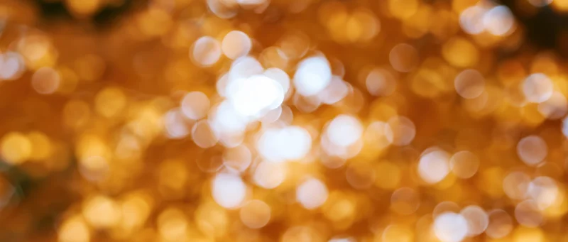 Blurred golden lights from autumn foliage creating a warm bokeh background