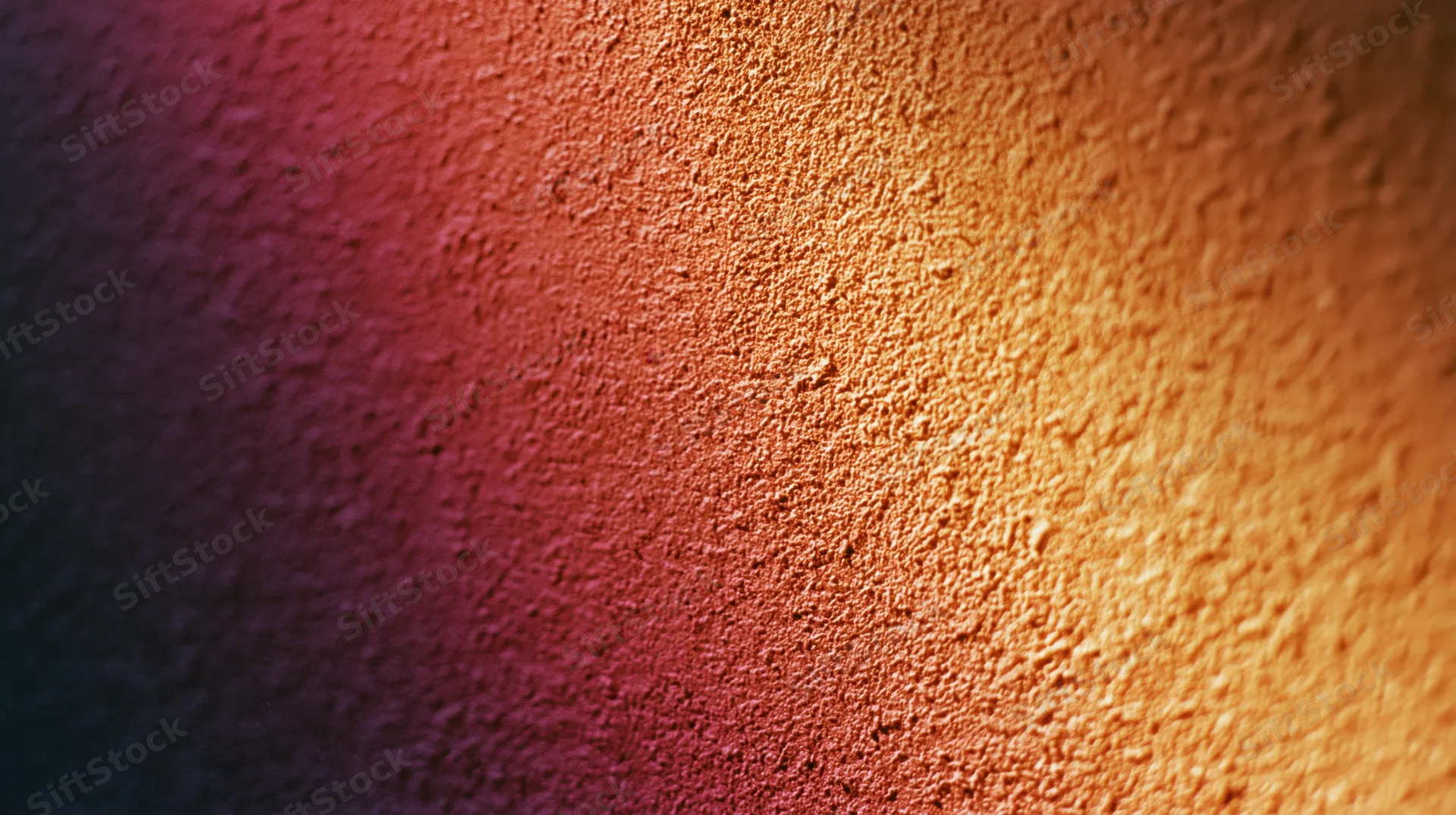 Close-up of a textured surface with a warm-to-cool gradient transitioning from orange to purple and blue