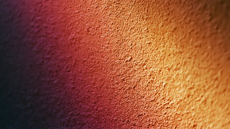 Close-up of a textured surface with a warm-to-cool gradient transitioning from orange to purple and blue