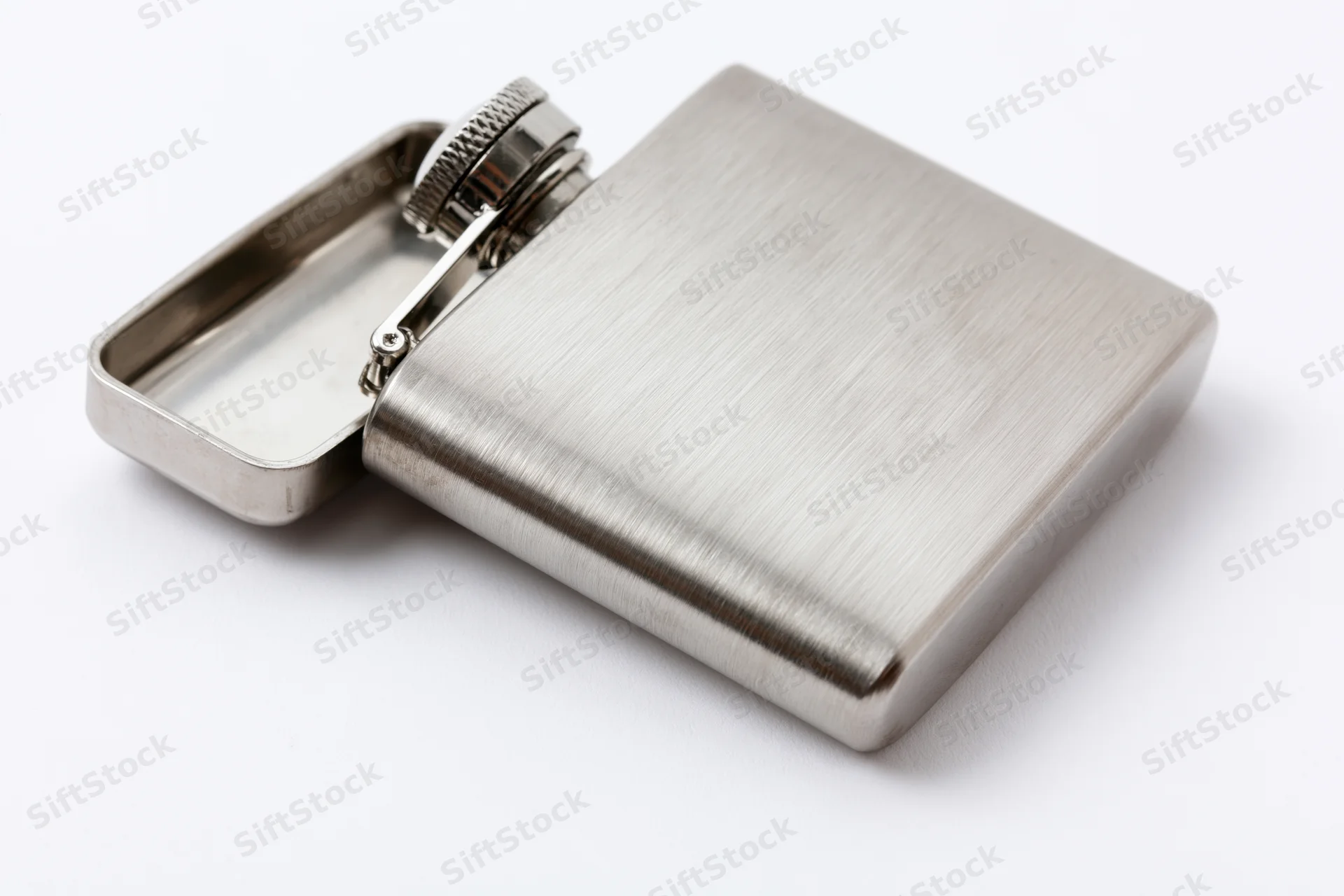 Open stainless steel hip flask with hinged cap on white background