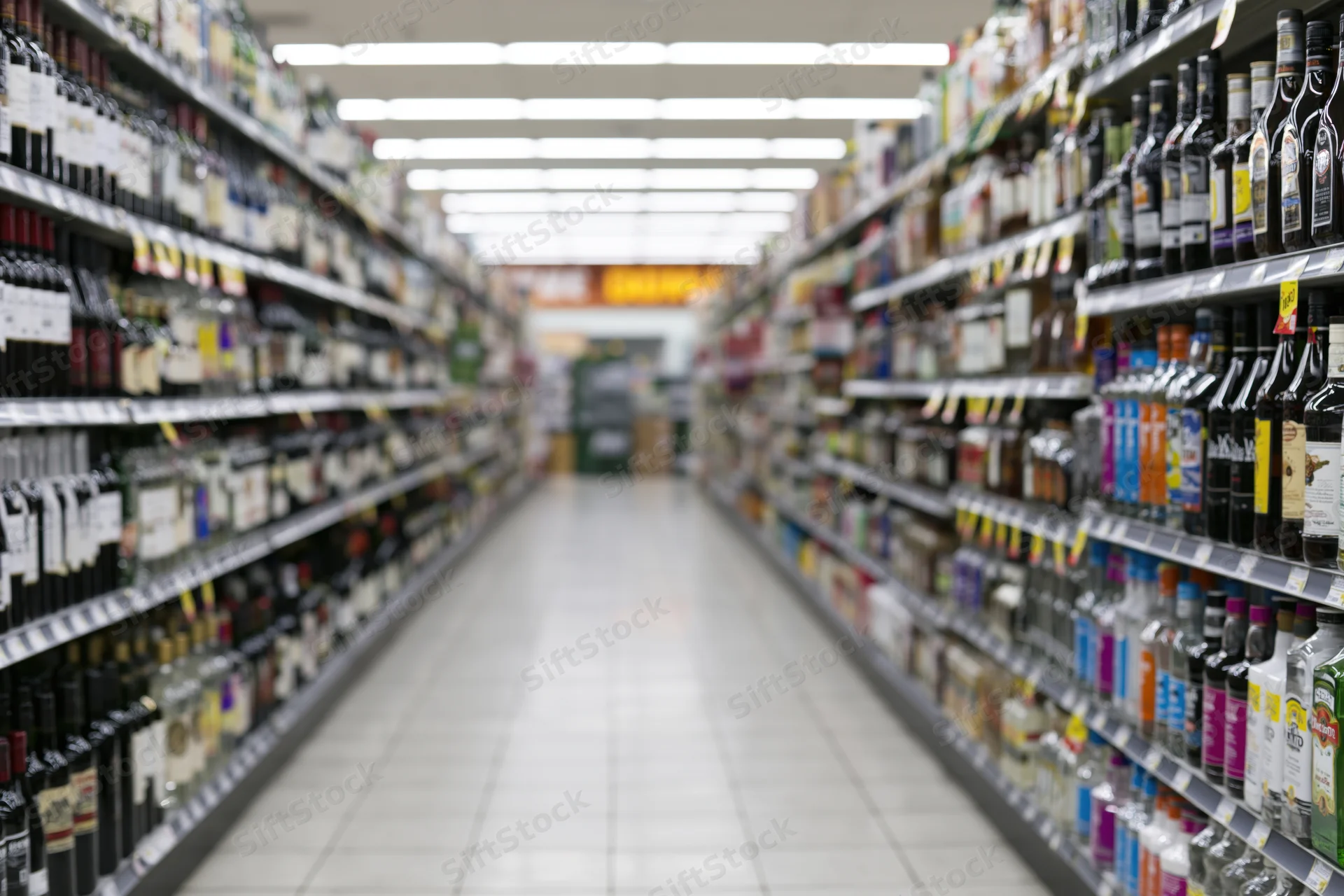 Empty liquor store aisle with shelves of bottles stretching into the distance