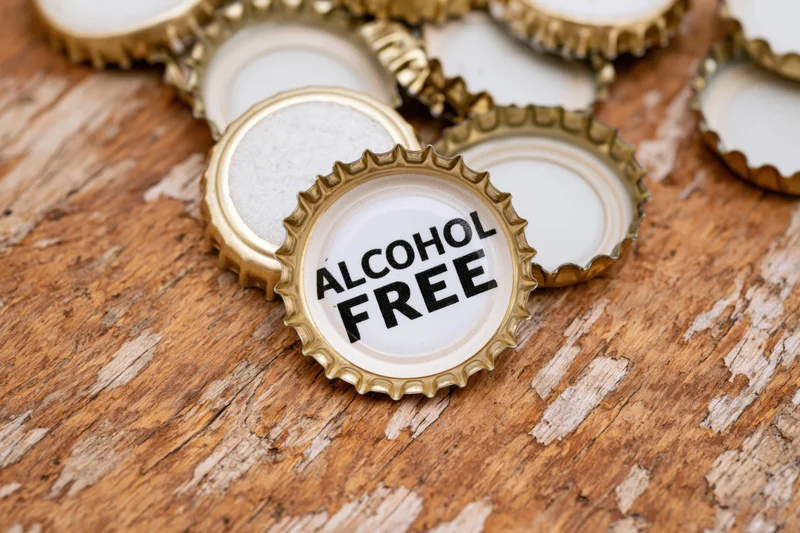 Bottle caps with alcohol free label on wooden surface