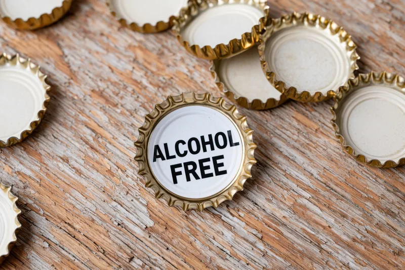 Bottle cap with alcohol free text on weathered wooden surface