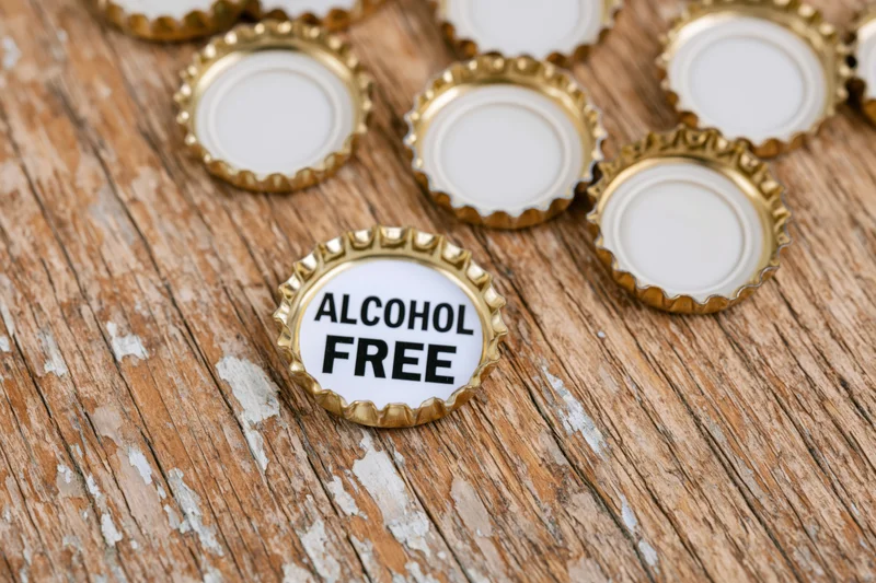 Bottle caps with alcohol free label on wooden surface