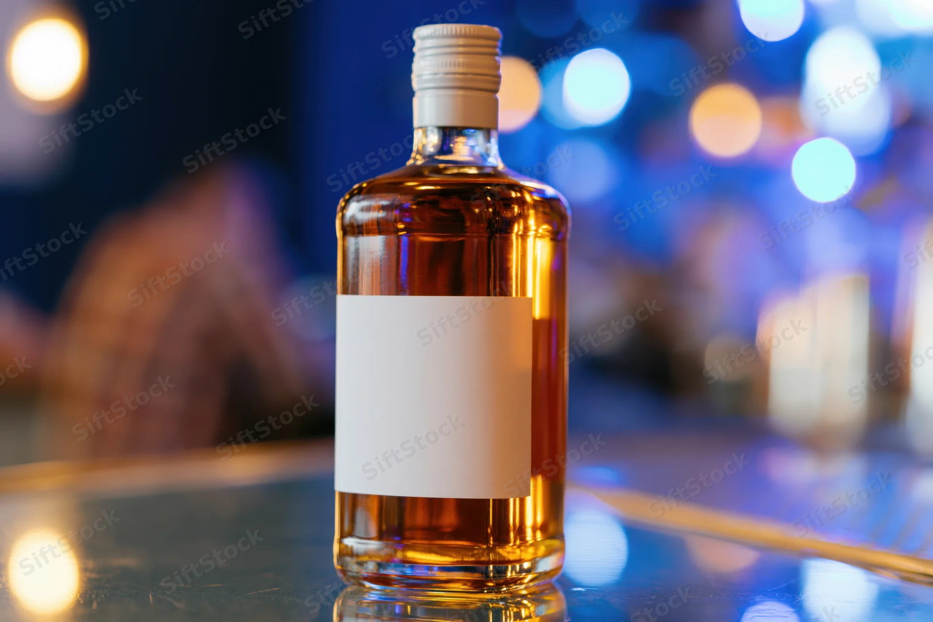 Whiskey bottle with blank label on reflective bar counter under ambient blue lighting