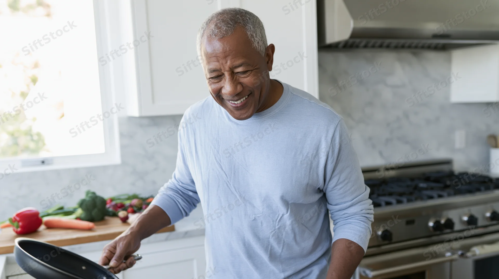 Senior africanamerican man smiling while cooking with a frying pan in a bright kitchen