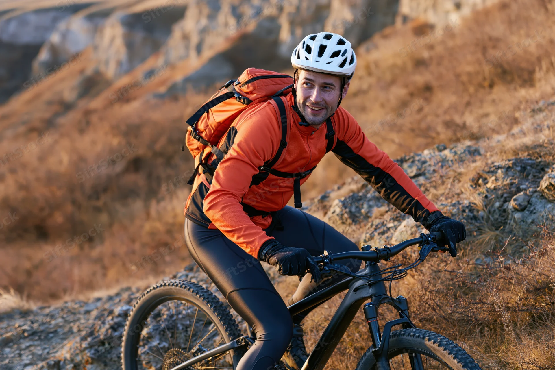 Man riding mountain bike on rocky trail in rugged outdoor terrain