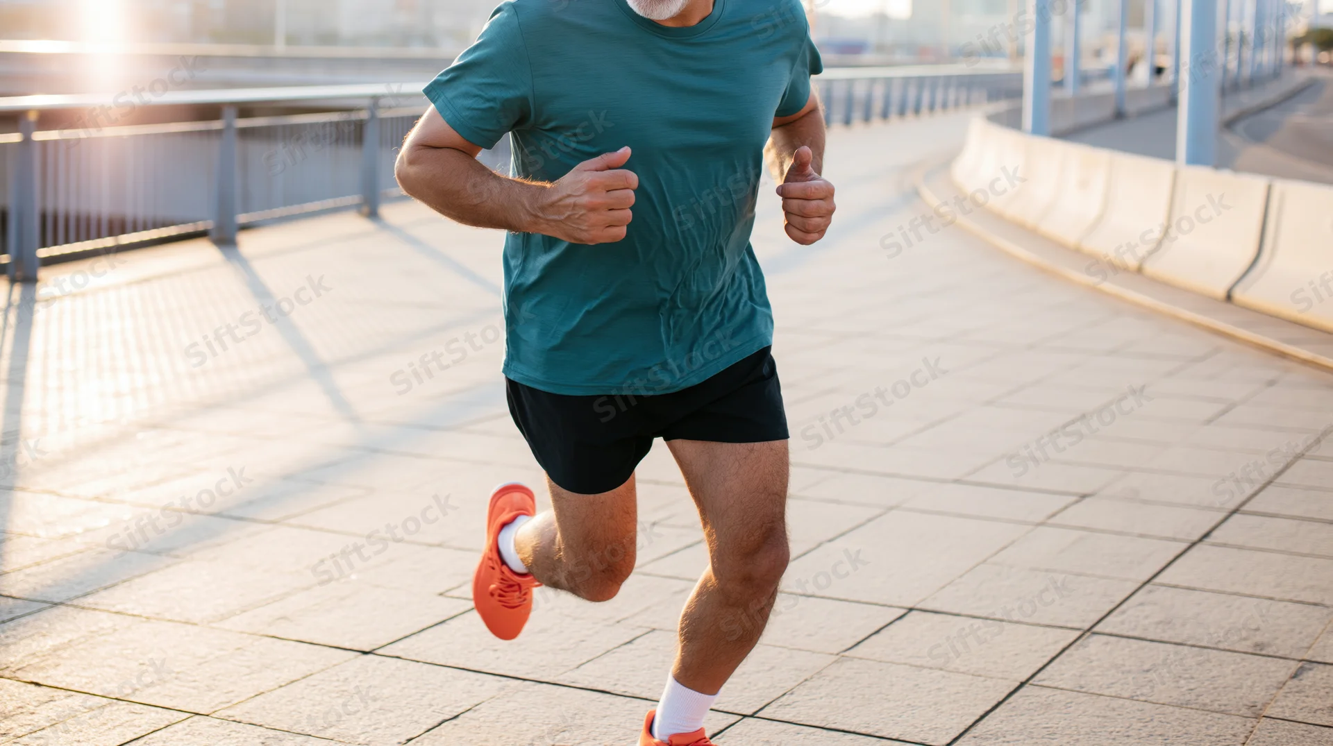 Middle-aged man running on a paved bridge in sunlight