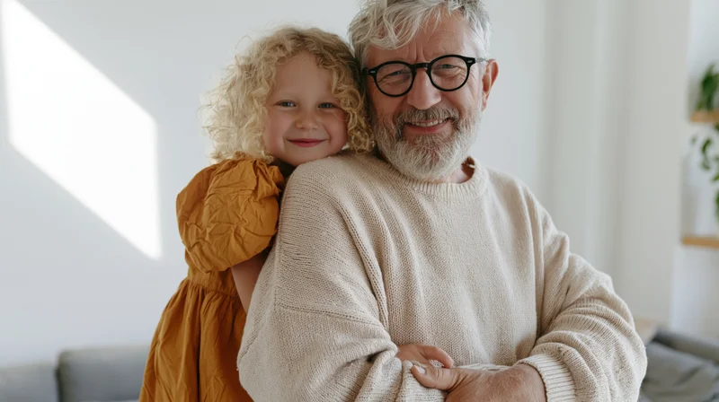 Grandfather hugging young girl in a sunlit living room