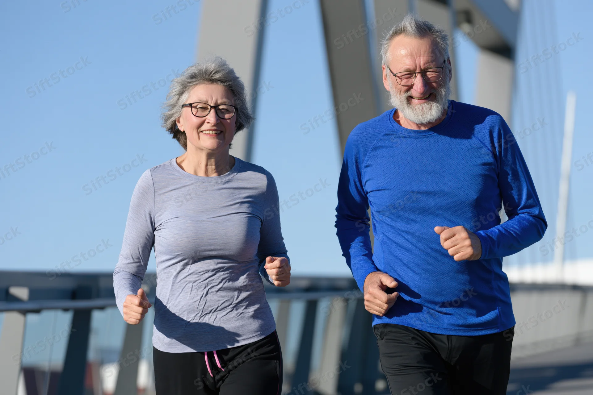 Older couple jogging side by side on a bridge in daylight