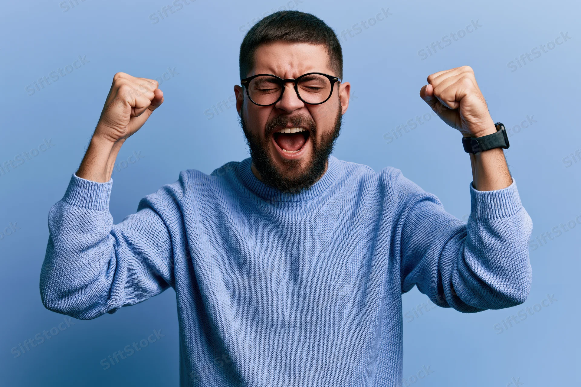 Man celebrating with raised fists and joyful expression against blue background