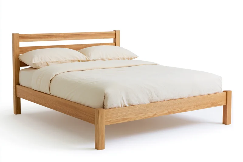Double bed with solid oak wooden frame and cream bedding on white background