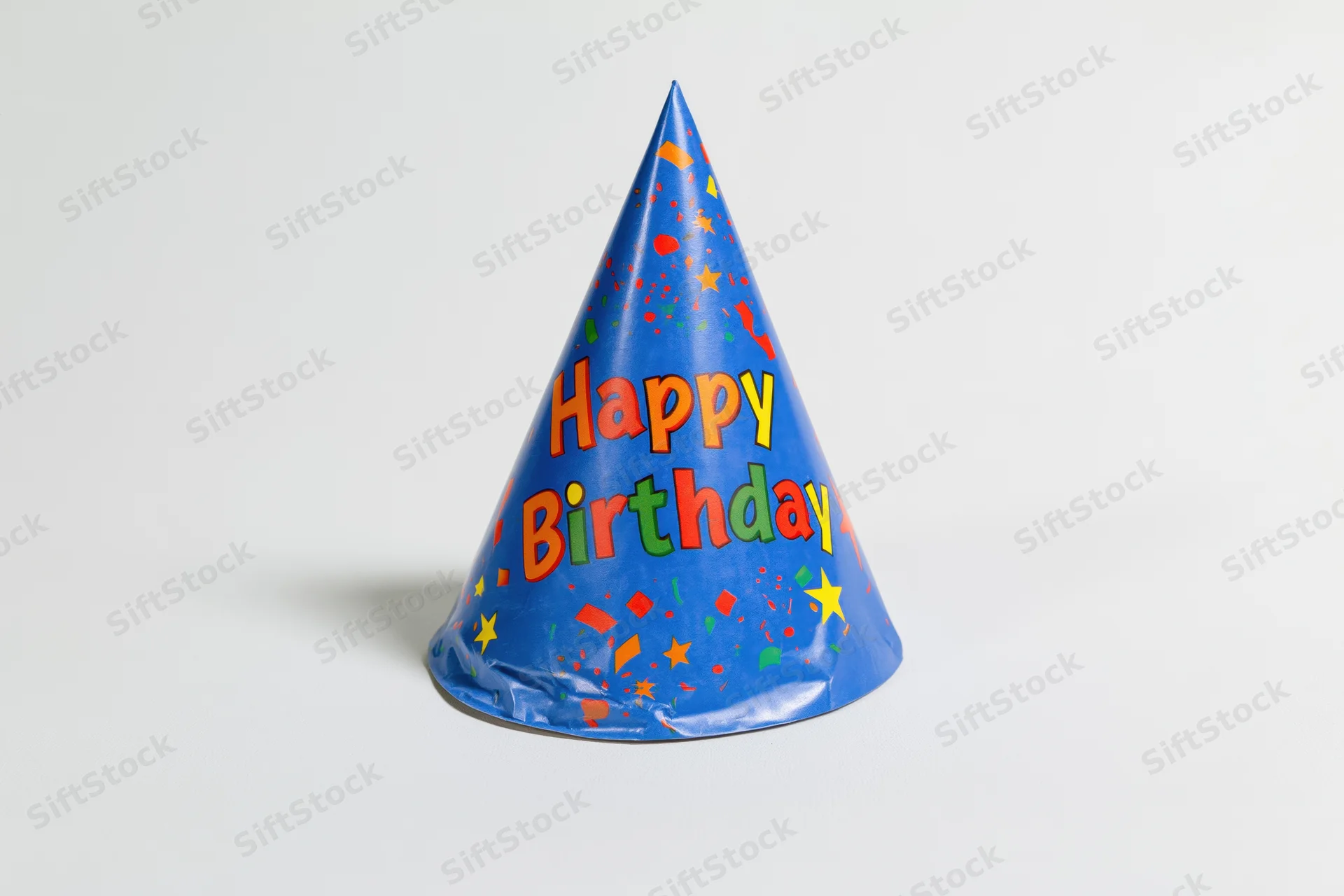 Blue paper birthday party hat standing upright on white background